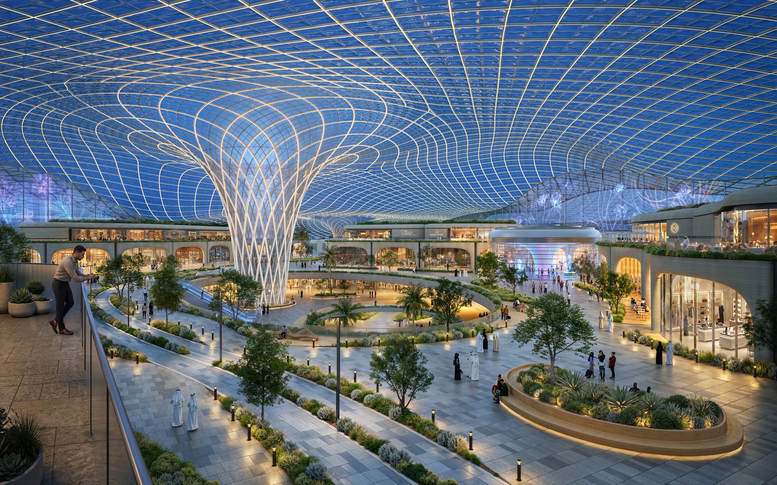 Inside the climate-controlled spine at Wadeem: a glazed canopy on branching columns over a landscaped boulevard with shops, walkways and cycle lanes