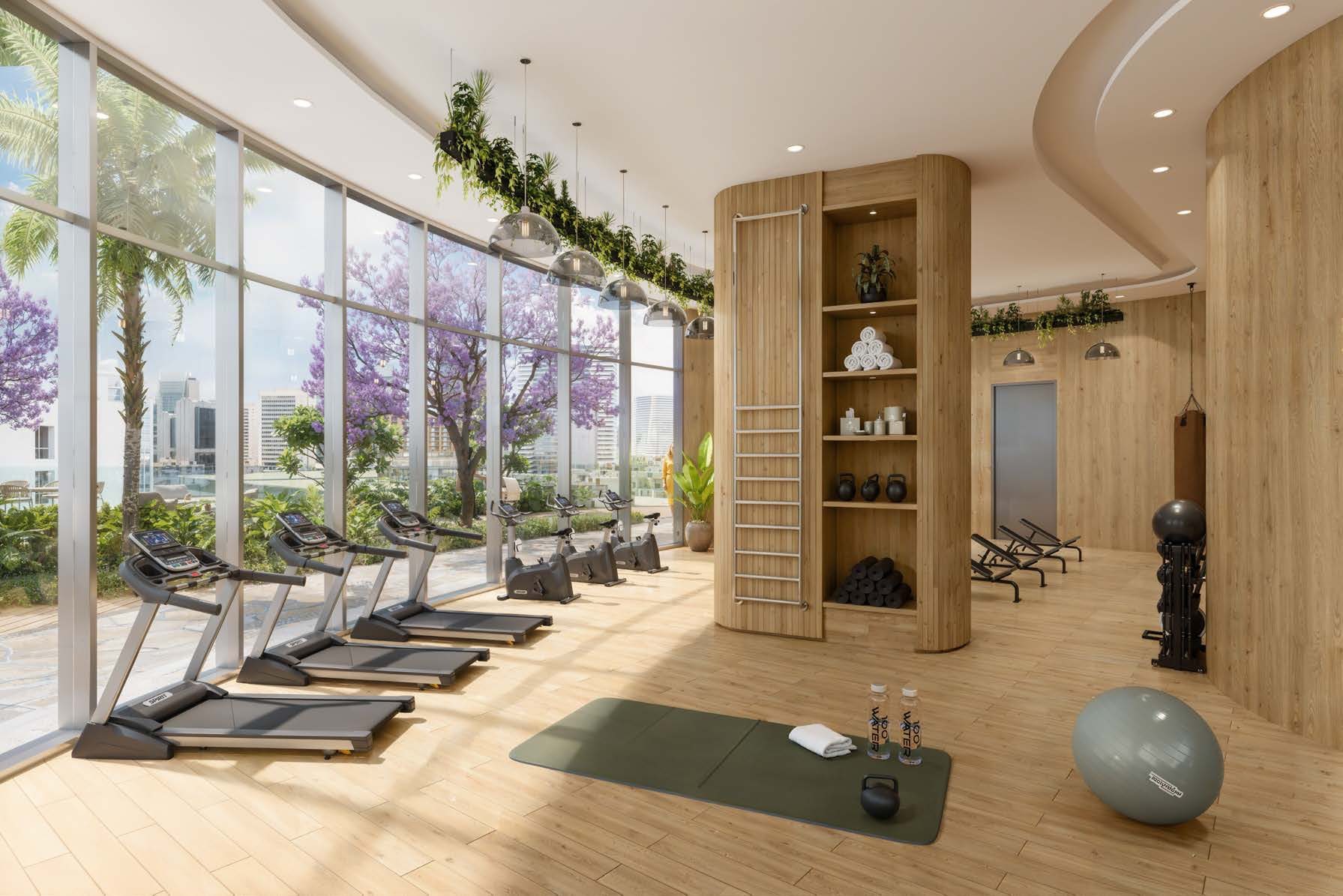 The fitness centre at Waterfront by Missoni, timber-lined with full-height glazing onto jacaranda trees