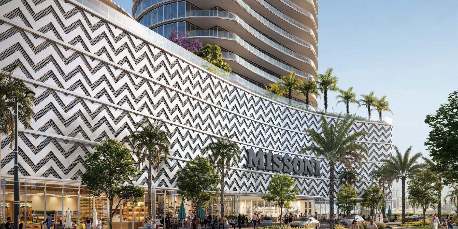 The podium of Waterfront by Missoni wrapped in the house's zigzag pattern, with MISSONI lettering above shops and a palm-lined walk